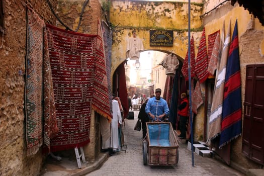 a smal Marketroad in the Medina of old City in the historical town of Fes in Morocco in north Africa.