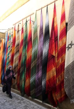 a smal Marketroad in the Medina of old City in the historical town of Fes in Morocco in north Africa.