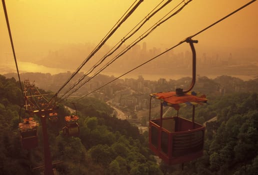 the cable car on the way over the yangzee River in the city of Chongqing in the province of Sichuan in china in east asia.