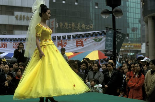 People at a fashion show at the main square in the city of Chongqing in the province of Sichuan in china in east asia.