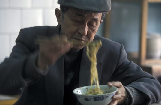 people with fast food on the Market streets of Chongqing in the province of Sichuan in china in east asia.
