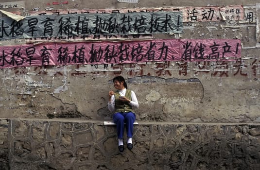a woman with a plate of rice near the town of Yangshou near the city of Guilin in the Province of Guangxi in china in east asia.