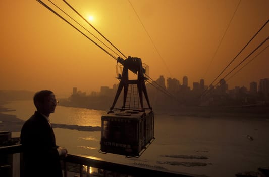 the cable car on the way over the yangzee River in the city of Chongqing in the province of Sichuan in china in east asia.