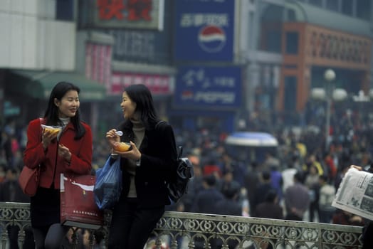 People at the main square in the city of Chongqing in the province of Sichuan in china in east asia.