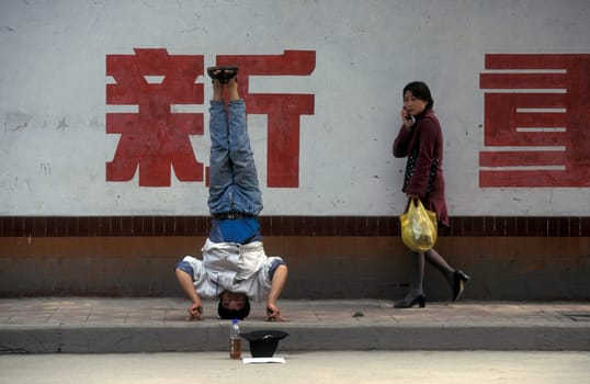 a men ask for money in the city of Chongqing in the province of Sichuan in china in east asia.