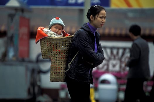 a mother with her baby in the city of Chongqing in the province of Sichuan in china in east asia.