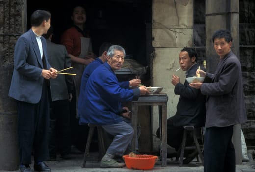People on the streets of Chongqing in the province of Sichuan in china in east asia.