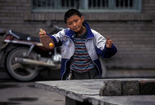 cilder play table tennis in the city of wushan on the yangzee river near the three gorges valley up of the three gorges dam project in the province of hubei in china.