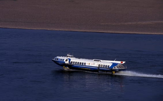 a speed boat at the landscape of the yangzee river in the three gorges valley up of the three gorges dam projecz in the province of hubei in china.