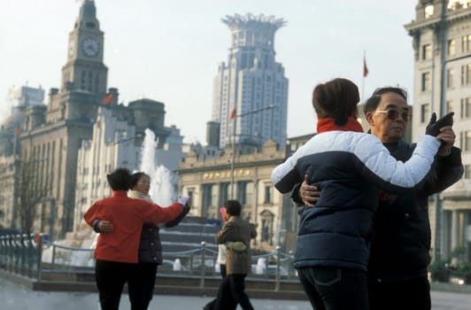 people dancing in the morning on the Bund in the City Shanghai in China.