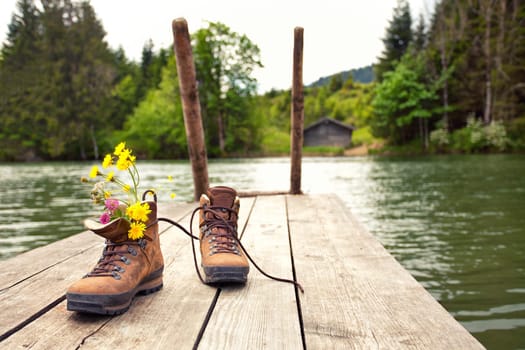 Hiking boots at the mountain lake