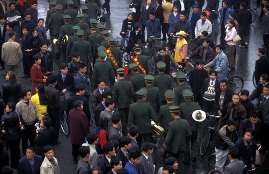 the police or army in the streets in the city of Chengdu in the province of Sichuan in centrall China.