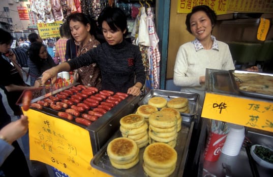 fast food in a market street in the city of Shenzhen north of Hongkong in the province of Guangdong in china in east asia.