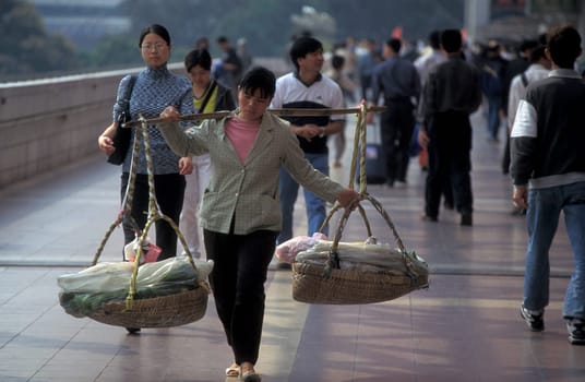 People in a market street in the city of Shenzhen north of Hong Kong in the province of Guangdong in china in east asia.