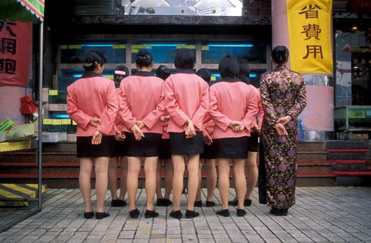 the restaraurant staff of a fish restaurant in the city of Shenzhen north of Hong Kong in the province of Guangdong in china in east asia.