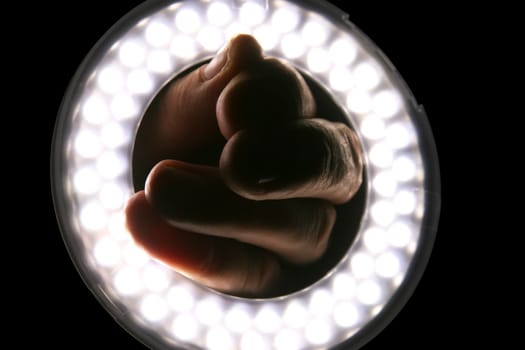 photographic ring flash with a hand in the centre