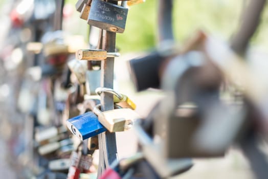 Love padlocks attached to the bridge. Europe. Wedding and marriage tradition.