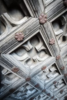 Old wooden door with floral ornament in street of old town of Gdansk, Poland, Europe.