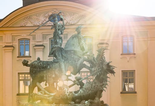 Statue of St. George and Dragon in old town of Stockholm Gamla Stan. Sun beaming in camera. Sweden, Scandinavia, Europe.