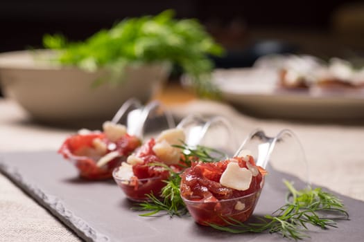 Appetizer with meat, Carpaccio and parmesan served on a Spoon