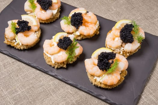 Shrimp Appetizer served on toasted bread and served on a slate plate