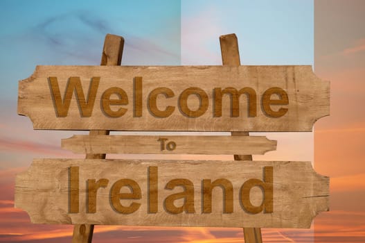 welcome to ireland sing on wood background with blending national flag
