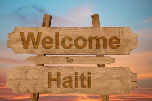 welcome to haiti sing on wood background