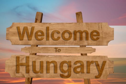 welcome to hungary sing on wood background with blending national flag