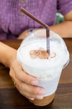 Woman hand holding iced coffee, stock photo