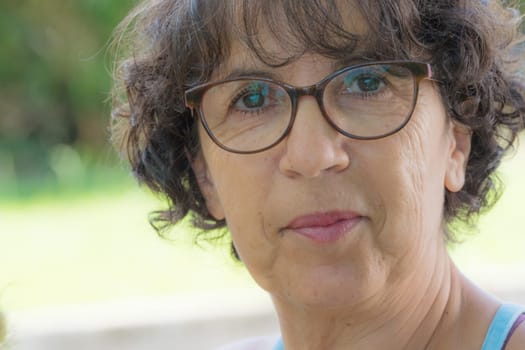 portrait of a beautiful mature woman with glasses