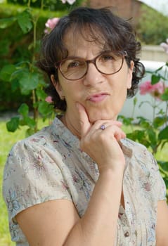 a middle aged woman with glasses in the garden