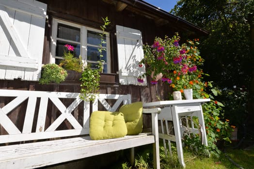 Garden hut in summer with lots of flowers