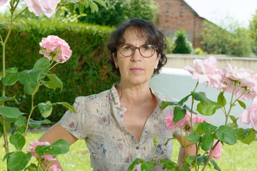 a middle aged woman with glasses in the garden