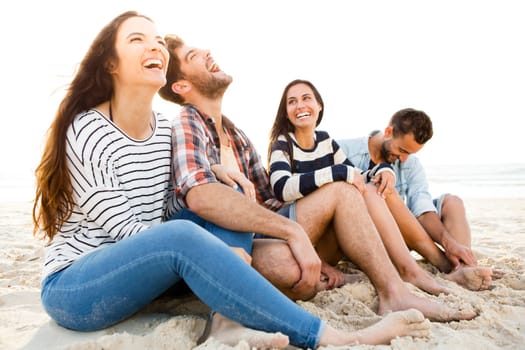 Group of friends at the beach having fun