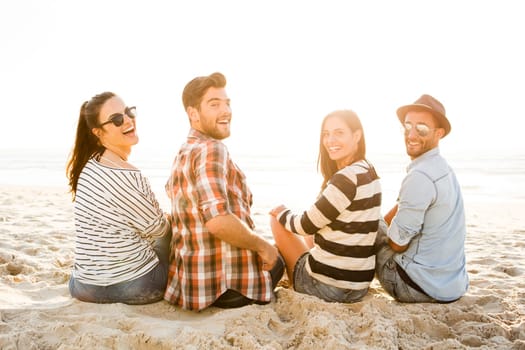 Group of friends at the beach having fun