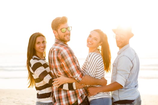 Group of friends at the beach and looking back