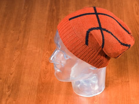 modern hat made of wool in a wooden background