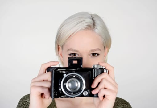 young woman with old camera