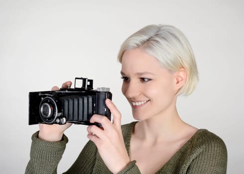 young woman with old camera