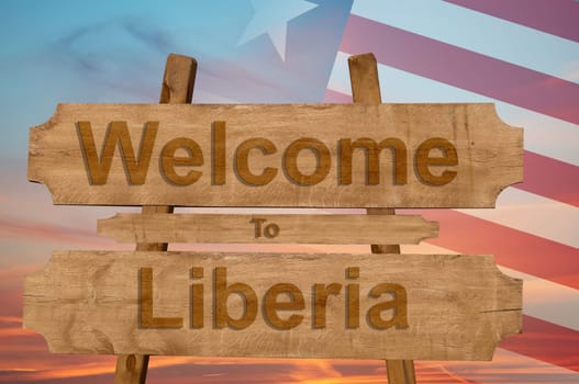 welcome to liberia sign on wood background with blending national flag