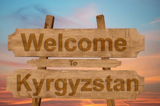 welcome to kyrgyzstan sign on wood background