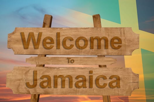 welcome to jamaica sign on wood background with blending national flag