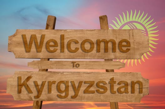 welcome to kyrgyzstan sign on wood background with blending national flag