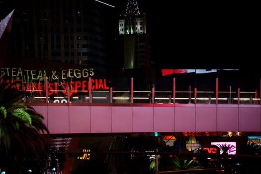 Las Vegas,United States - December 23,2015: The abstract reflections of lights and advertising of Las Vegas Boulevard in the glass railing of a pedestrian bridge on December 23,2015 in Las Vegas.
