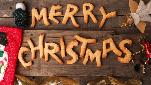 Sweet homemade cookies with the words Merry Christmas on a rustic wooden background