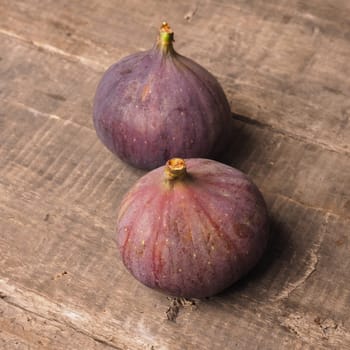 Fresh organic figs on a rustic wooden table, healthy food concept