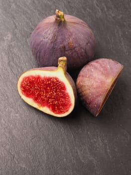 Fresh organic figs on a dark slate background, healthy food