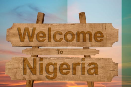 welcome to jamaica sign on wood background with blending national flag