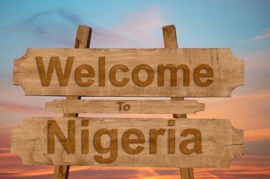 welcome to jamaica sign on wood background with blending national flag