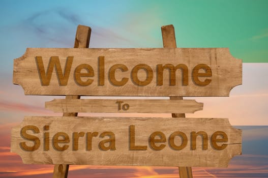 welcome to jamaica sign on wood background with blending national flag
